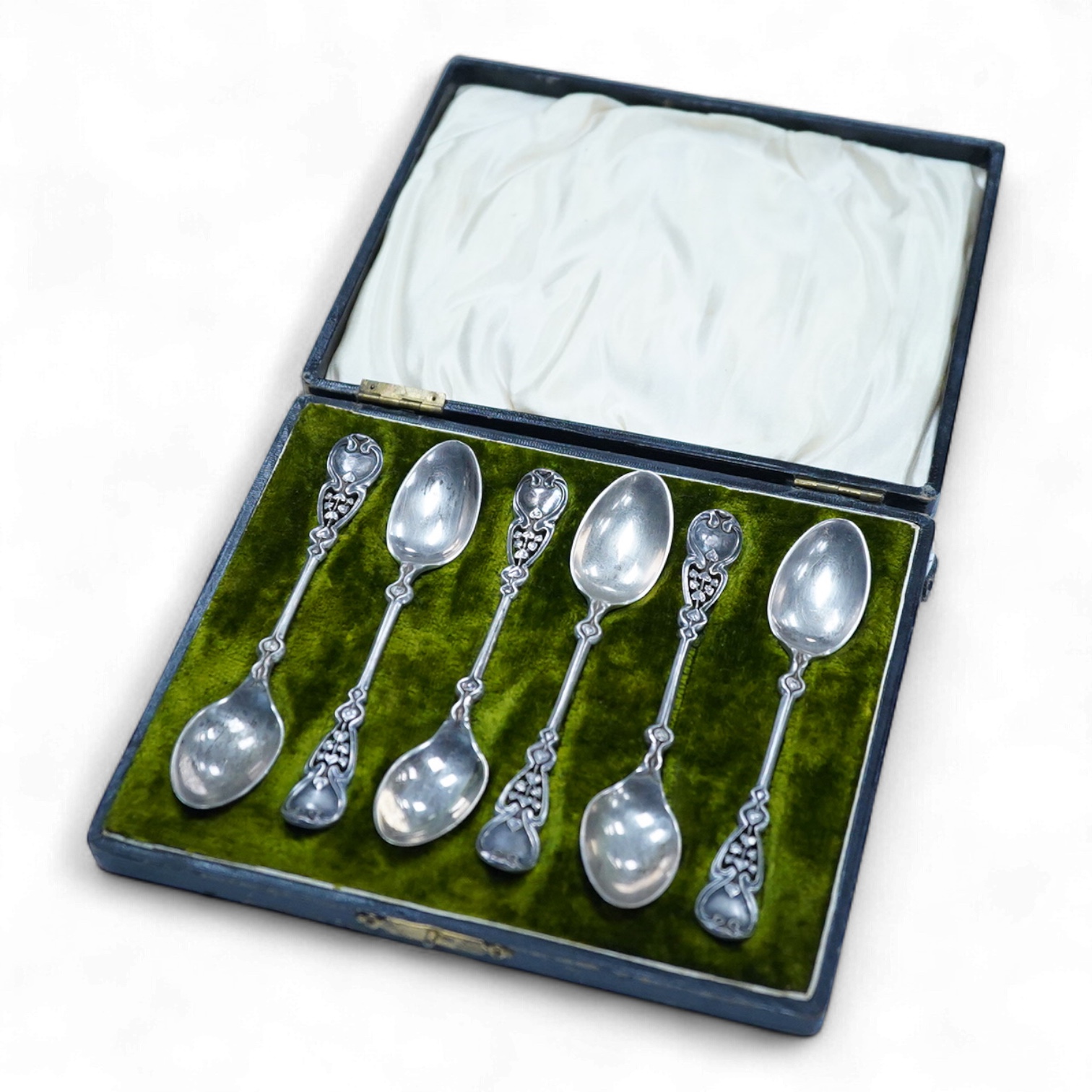 A cased set of six Edwardian Art Nouveau silver coffee spoons, Joseph Rodgers & Sons, Sheffield, 1908, 10.9cm, with pierced stylised terminals.